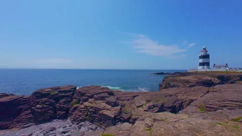 Coastal view of lighthouse under bright sunny sky, natural landscape scenery Stock Footage 340451001