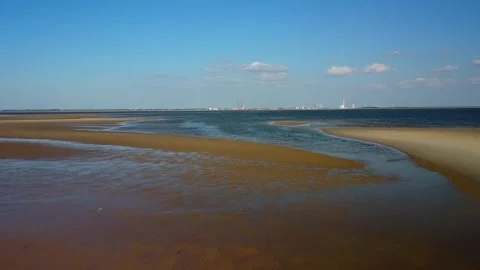 Coastal view at low tide with sandbars revealing water and shoreline near a.. Stock Footage 339940707