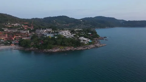 Coastal view of resort area with lush greenery and calm ocean waters Video stock 340406892