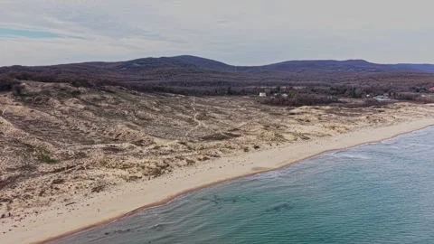 Coastal view with sandy beach and rolling hills at early afternoon Stock Footage 325720417