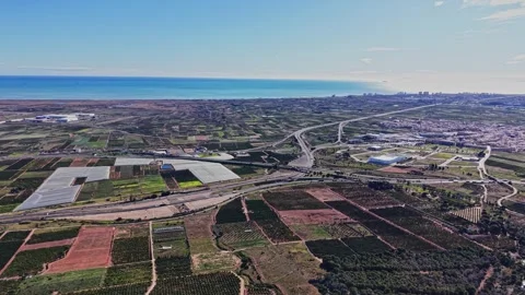 Coastal view in Spain showing fields, roads, and sea in the distance Stock Footage 327644495