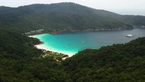 Coastal view of turtle beach on Redang Island, surrounded by lush green hills Stock Footage 321296072
