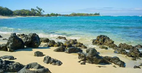 Coastal View Of Waves Hitting Rocks On Shore Of Sandy Beach Stock Photos