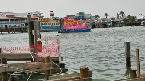 Coastal Waterfront View to Johns Pass Boardwalk across  damaged pier. Madeira Be Stock Footage 312761107