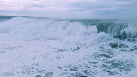 Coastal Waves Crashing Under a Cloudy Sky Stock Footage 296696400