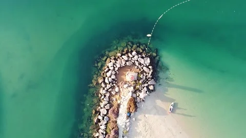 Coastal zippy with small lighthouse. aerial shot. flying up Stock Footage
