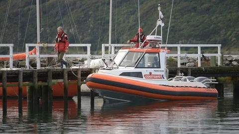 Coastguard man walking down wharf Stock Footage 113831180