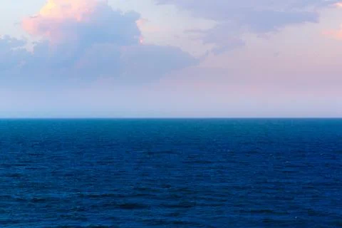 Coastline of the sea in the rays of the setting sun Stock Photos