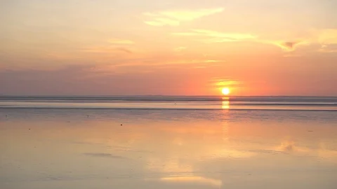 The coastline of the Wadden sea, Germany at sunset, sun shines bright Stock Footage