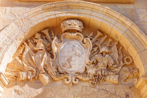 Coat of arms over arch entry in ancient part of Mdina, old capital of Malta. Stock Photos