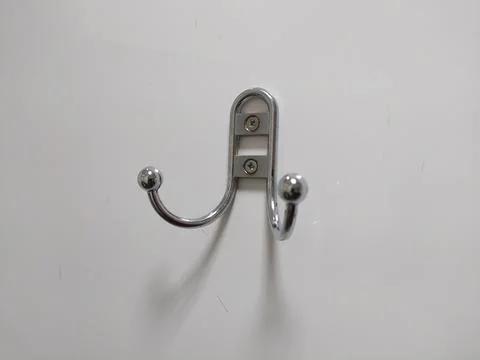 Coat or bag hook with two horns on white wall or door Stock Photos