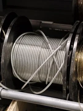 Coated wire rope inventory organized on black plastic spools in a construct.. Stock Photos