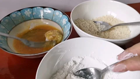 Coating Chicken Nuggets with Beaten Egg Stock Footage 231360808