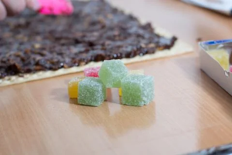 Coating chocolate topping with wallnuts on cake crust Stock Photos