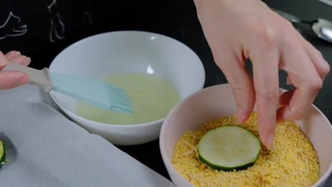 Coating Zucchini Slices in Batter and Breadcrumbs Cooking Video stock 341461406