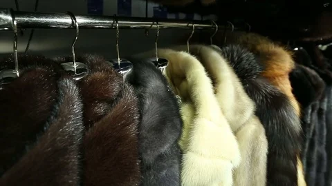 The coats on the rack in the store, the camera moves Stock Footage 78377581