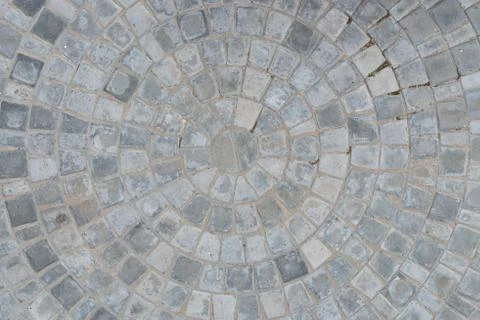 Cobble circular pattern block pavement texture background. Top view Stock Photos