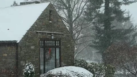A Cobble Home During a Snowstorm Stock Footage 145167698
