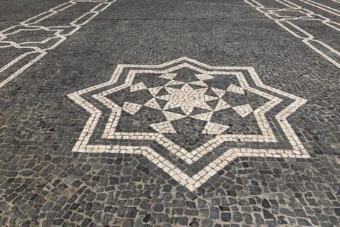 Cobbled textured background with eight pointed star mosaic ornament Stock Photos