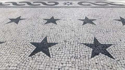 Cobbled textured background with five pointed star mosaic ornament Stock Photos