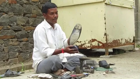 Cobbler doing boot polish Stock Footage 77571988