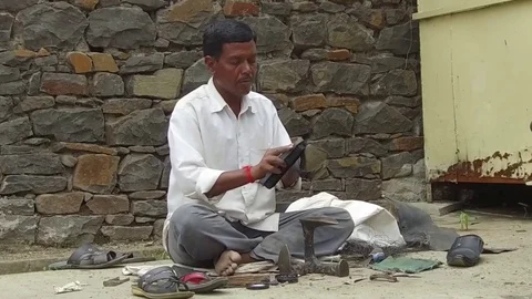 Cobbler doing boot polish Stock Footage 77572176