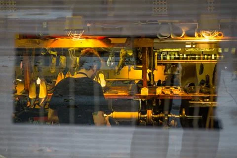Cobbler working on shoe, through window in Montreal Foto stock