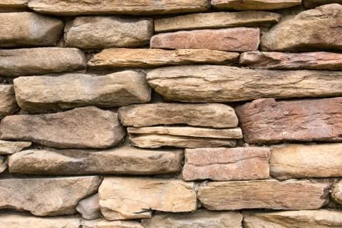 Cobblestone bricks in a brick wall. Stock Photos