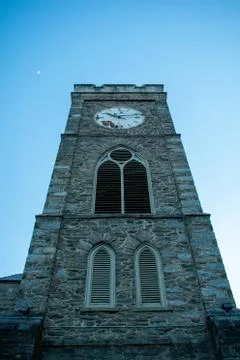 A Cobblestone Clocktower on a Clear Blue Sky Stock Photos