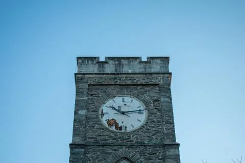A Cobblestone Clocktower on a Clear Blue Sky Stock Photos