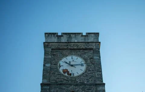 A Cobblestone Clocktower on a Clear Blue Sky Stock Photos