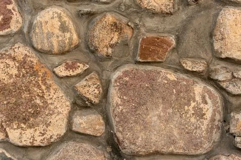 Cobblestone masonry, close-up stone wall, stone background, cobblestone pattern 写真素材