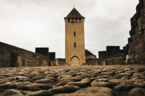 Cobblestone path leading to an ancient medieval tower Stock Photos