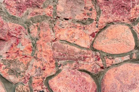 Cobblestone pattern, close-up stone wall, cobblestone masonry, stone background Stock Photos