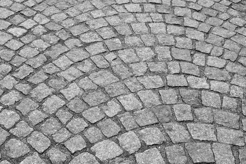 Cobblestone pavement in a circular pattern, featuring gray stones with vary.. Stock Photos