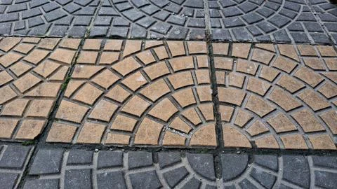 Cobblestone pavement ground texture with geometric patterns outdoors Stock Photos