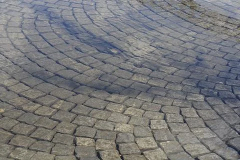 Cobblestone pavement pattern under a clear water ripple Stock Photos