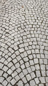 Cobblestone pavement texture background. Cobblestone pavement background. Stock Photos