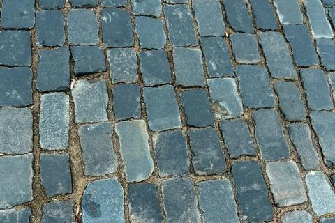 Cobblestone pavement texture top view. Ancient stone blocks of a city stree.. Stock Photos