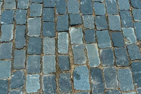 Cobblestone pavement texture top view. Ancient stone blocks of a city stree.. Stock Photos