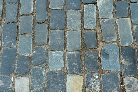 Cobblestone pavement texture top view. Ancient stone blocks of a city stree.. Stock Photos