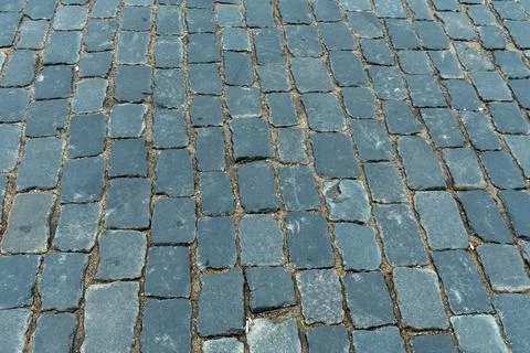 Cobblestone pavement texture top view. Ancient stone blocks of a city stree.. Stock Photos