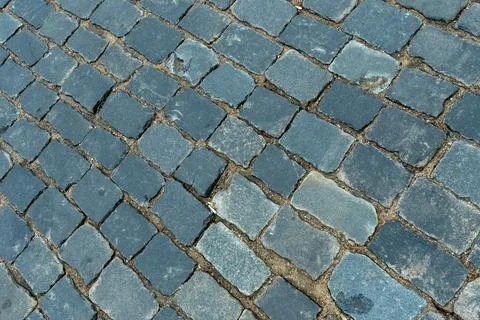 Cobblestone pavement texture top view. Ancient stone blocks of a city stree.. Stock Photos