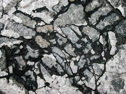 Cobblestone road surface. Old stone road. Broken stone effect. Stock Photos