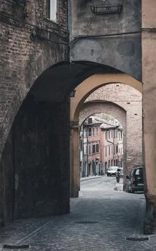 A   cobblestone   street   through   an   archway Stock Photos
