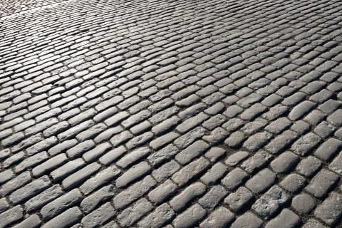 Cobblestones lighted by the sun Stock Photos