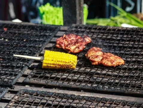 The cobs of yellow corn on the grill Stock Photos