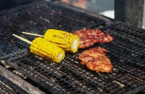 The cobs of yellow corn on the grill Stock Photos