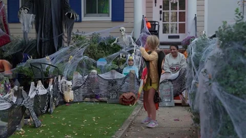 Cobweb decorations and children in costume outside a house on Capitol Hill Stock Footage 345299576