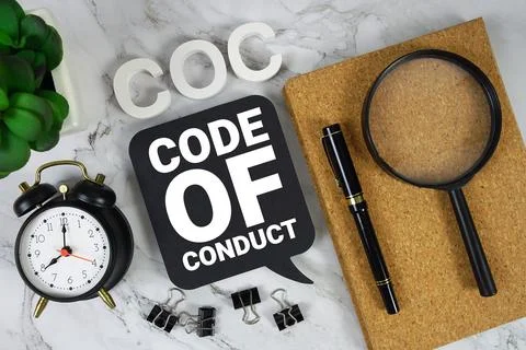 COC Code of Conduct text with alarm clock and magnifying glass on marble ba.. Stockfoto's